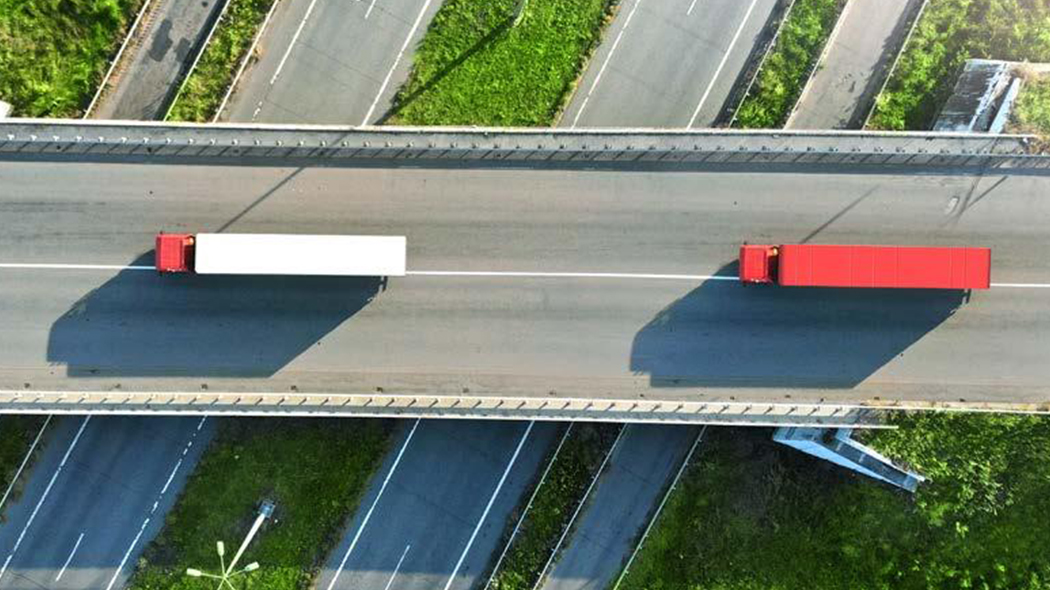 Bird's eye view of highway roads with trucks