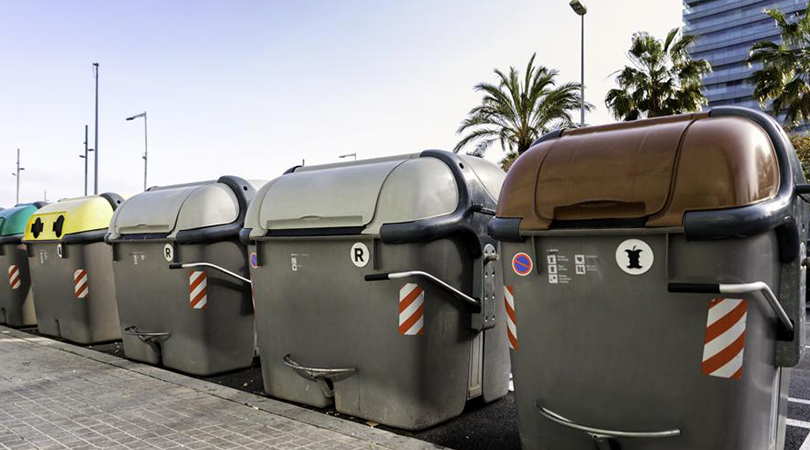 Different colored smart trash containers side by side