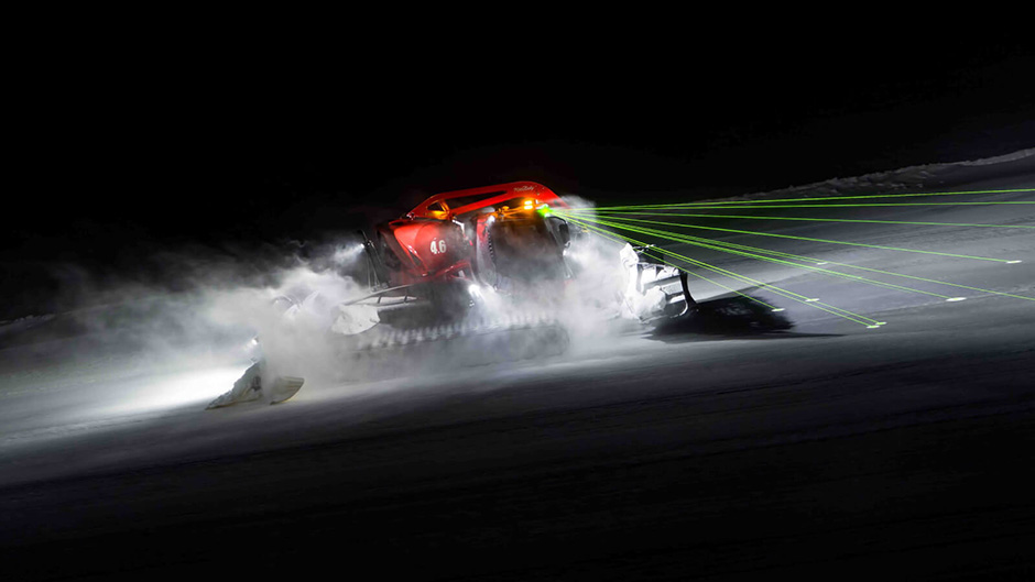 A PistenBully at work by night using LiDAR laser beams