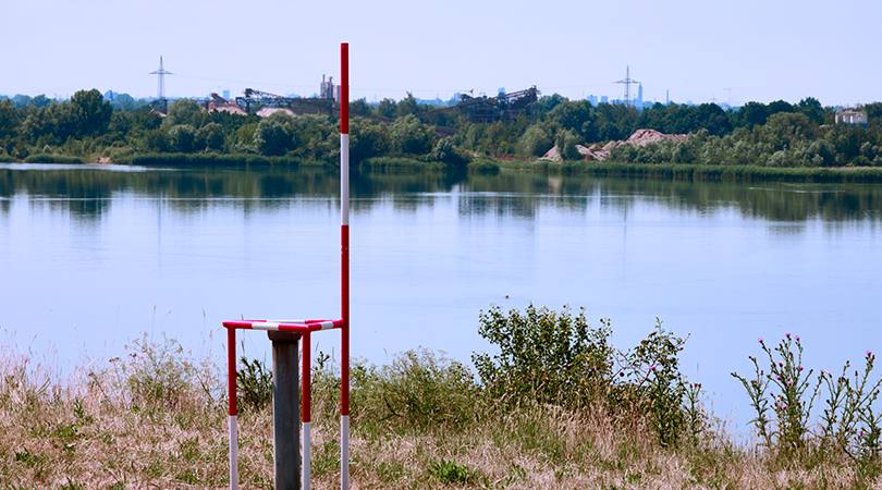 A measuring point for monitoring the groundwater level and water quality of a flooded gravel pit.