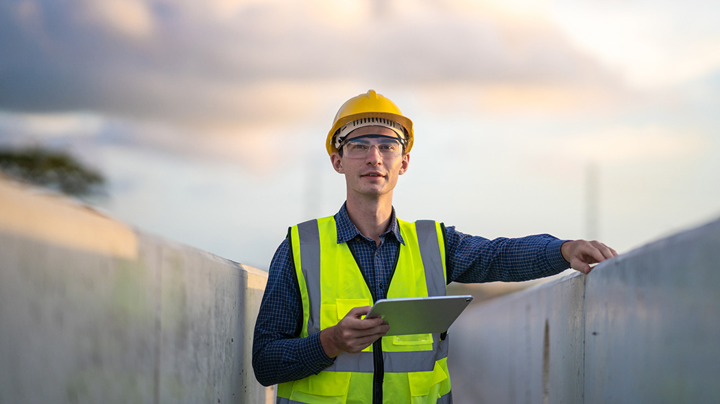 Employee with tablet on a construction site