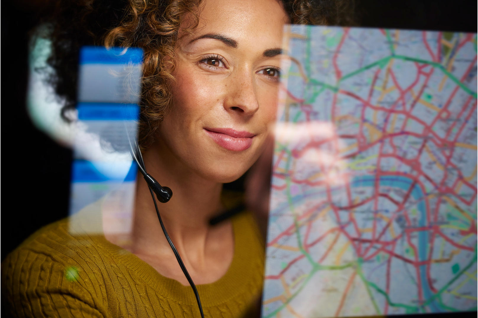 Woman with headset looking at a Map