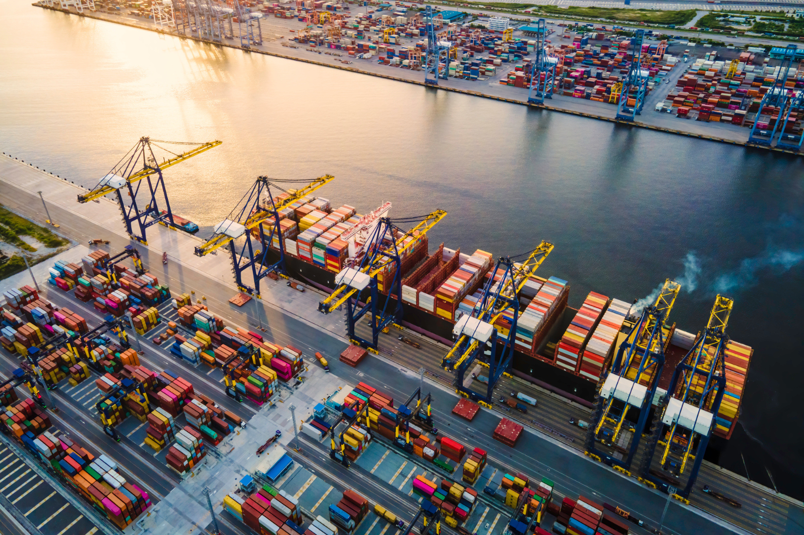 Cargo port with container ships and cranes, central to global trade.