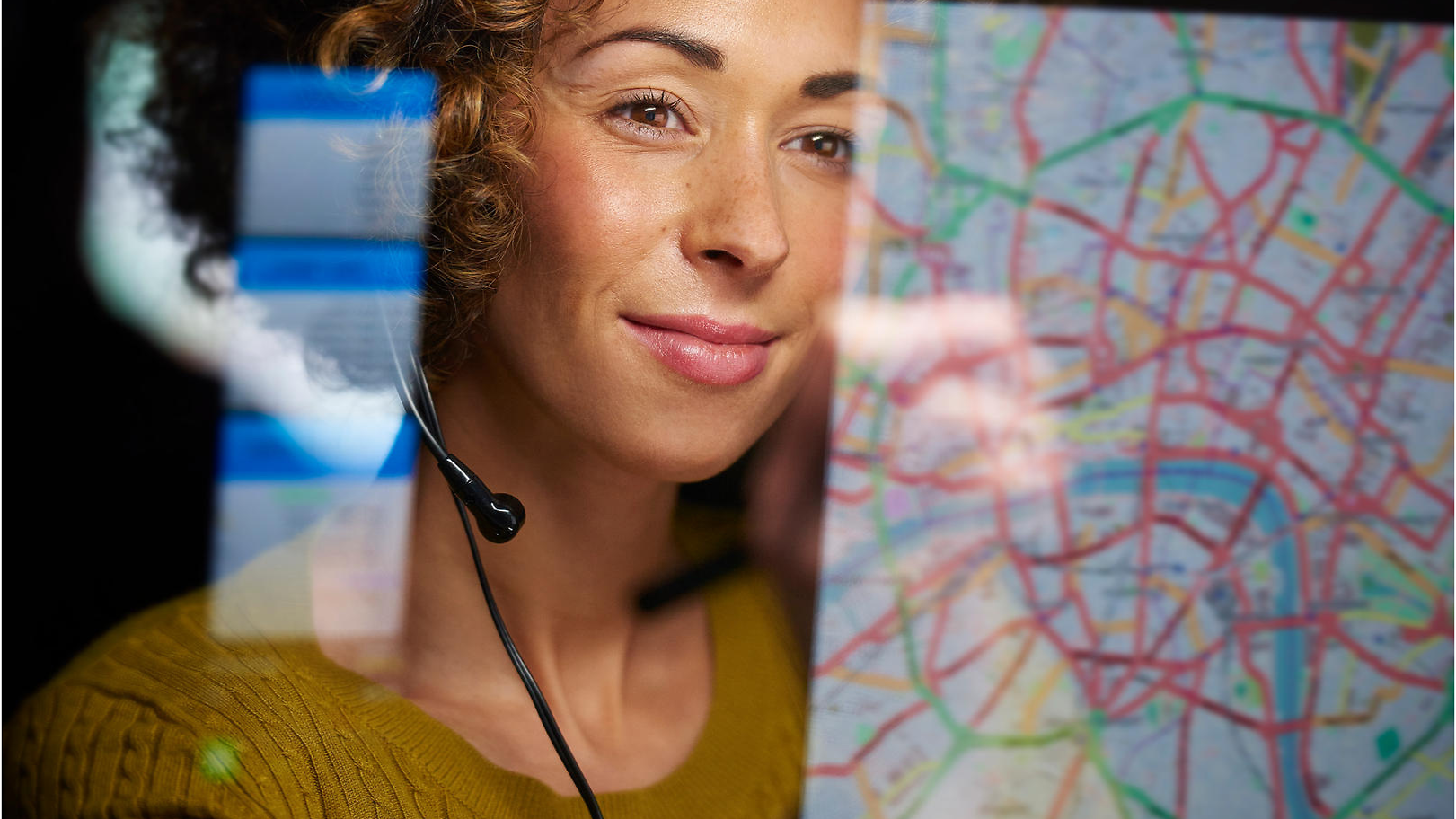 Woman with headset looking at a Map
