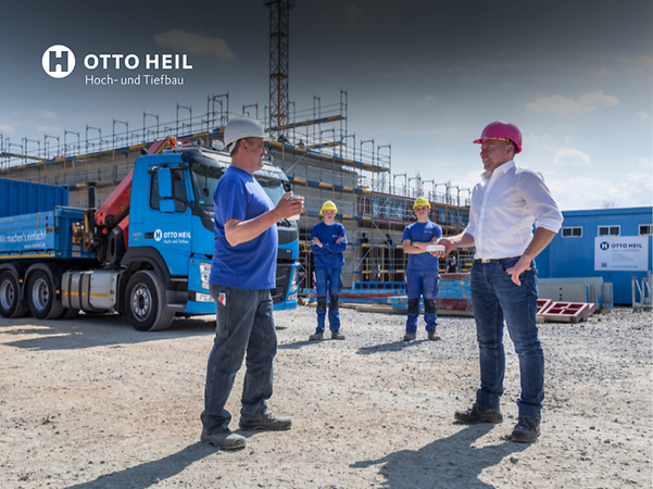 Blick auf die Baustelle: Ein Arbeiter redet mit einem Vertreter von Telekom IOT