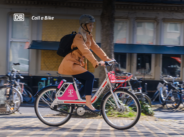 A woman uses Call a Bike, the bike sharing service of Deutsche Bahn