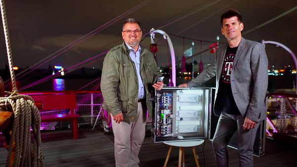 Two men standing in front of a lighting control