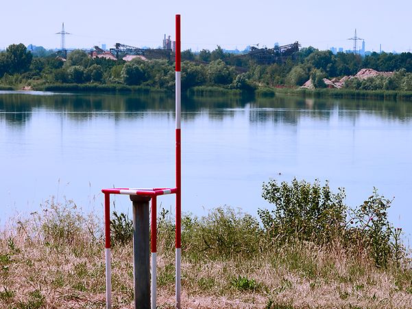 Measuring point for monitoring the groundwater level and water quality of a quarry pond.
