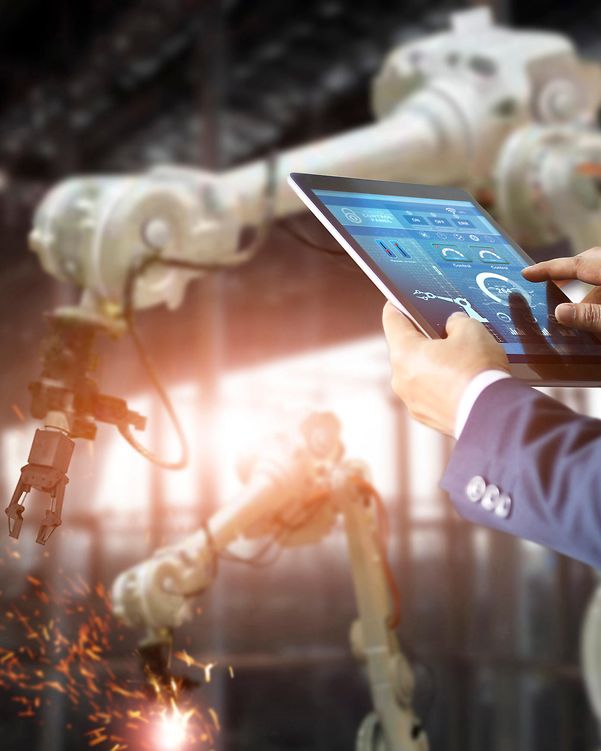 Person with tablet in front of a production facility