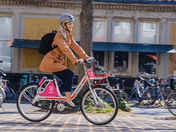 A woman uses Call a Bike, Deutsche Bahn's bikesharing service