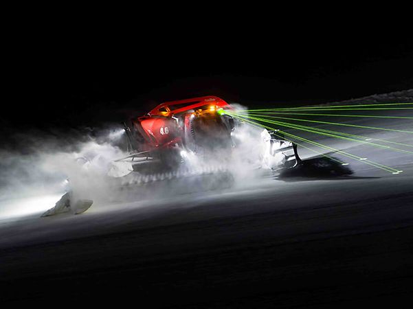 PistenBully in action at night with LiDAR laser beams
