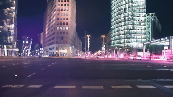View of a street with tall buildings at night