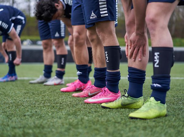 Legs of football players with a foot sensor