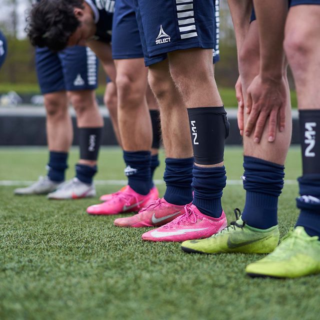 Legs of football players with a foot sensor