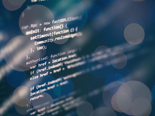 Abstract visualization of programming code with blurred light effects.