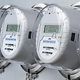 Row of modern digital electricity meters on a building wall.
