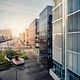 Modern buildings with glass facades and green spaces symbolize the future of smart building management