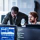Two people in the office analyze IoT data on the computer