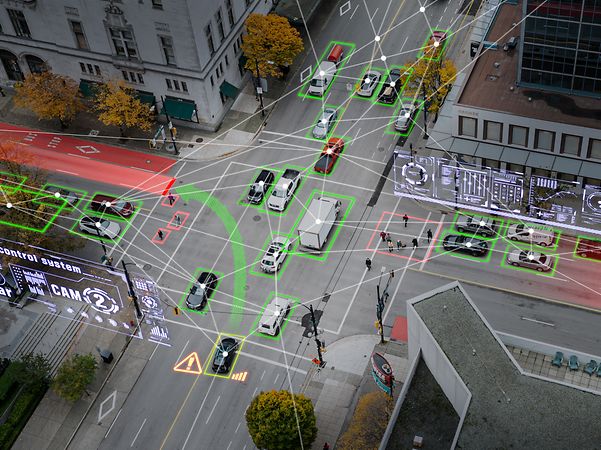 Smart city intersection with connected vehicles and digital traffic data overlay.
