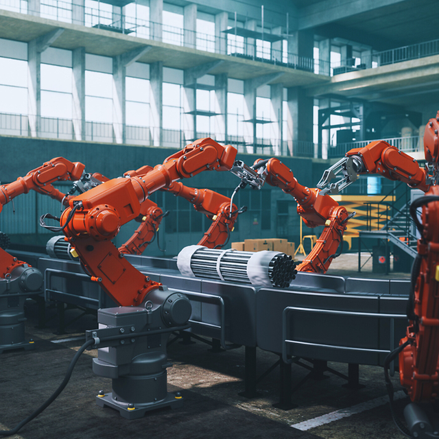 Factory hall with robot arms and production line
