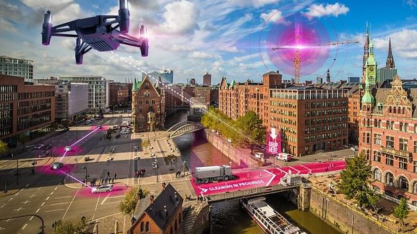 En drönare flyger över staden och använder precisionspositionering för att lokalisera autonoma maskiner med centimeterprecision