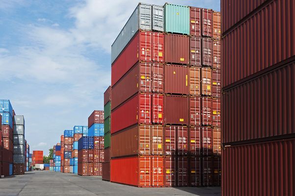 Stacked shipping containers in a port for transport and logistics.