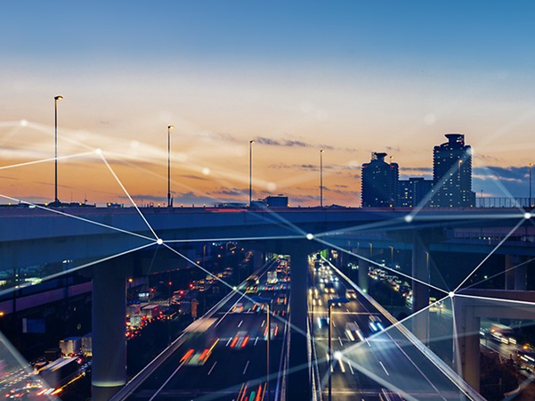 Abstract lines and dots connecting above a highway at night.