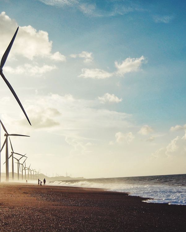 Wind turbines at sea generating sustainable energy as part of critical infrastructure.
