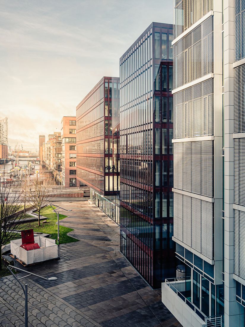 Modern buildings with glass facades and green spaces symbolize the future of smart building management