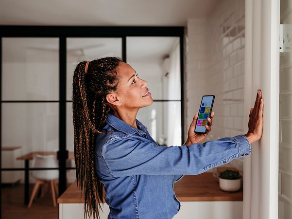 An employee checks the energy consumption of a heating system